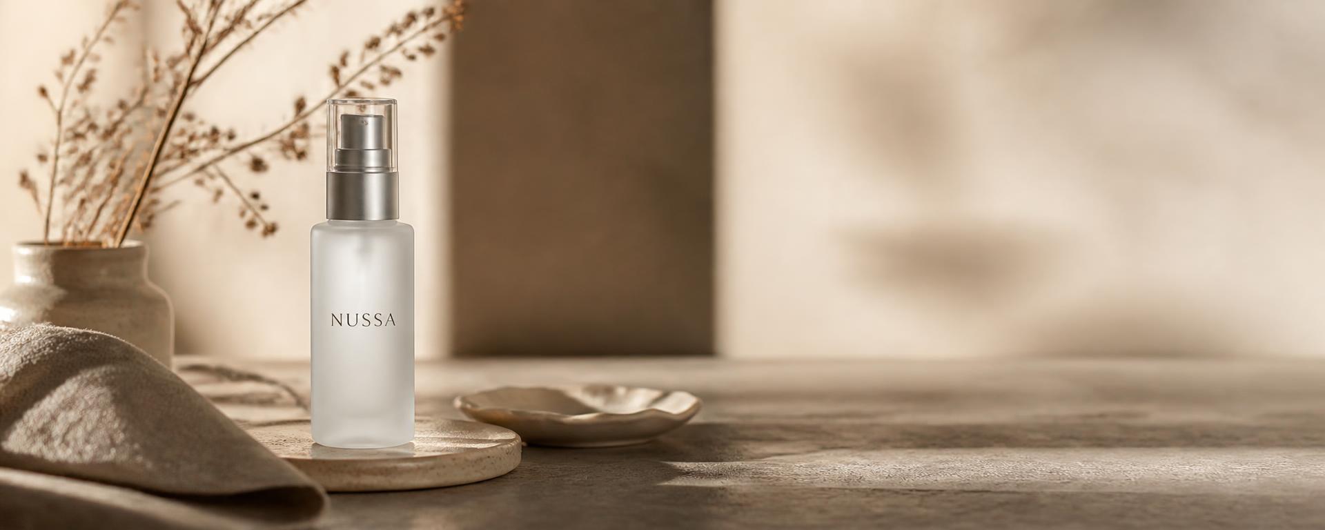 Styled product shoot table with the NUSSA serum bottle